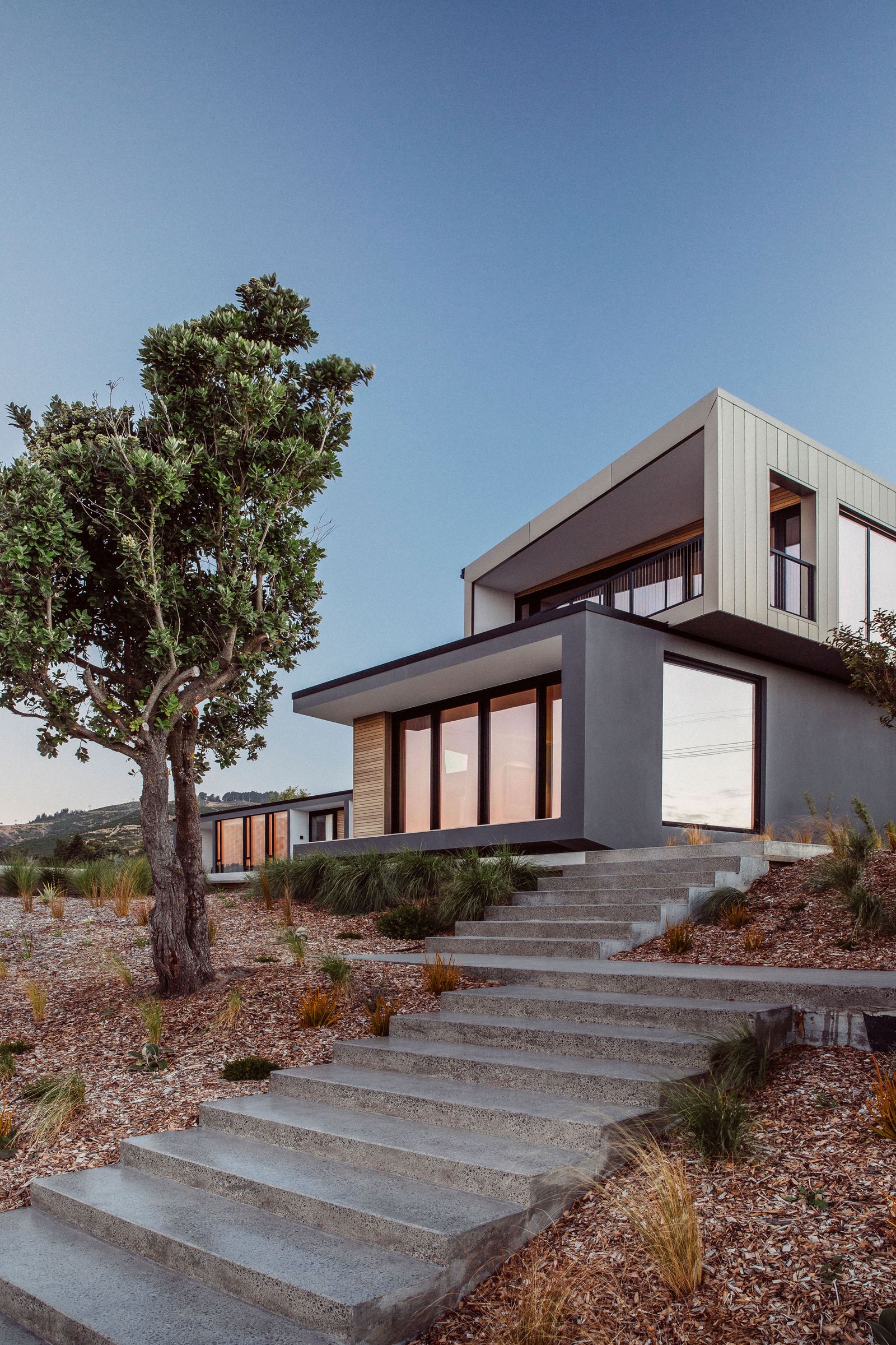 Worsley Spur, Cashmere – Port Hills house with bronze anodised upper level by AW Architects