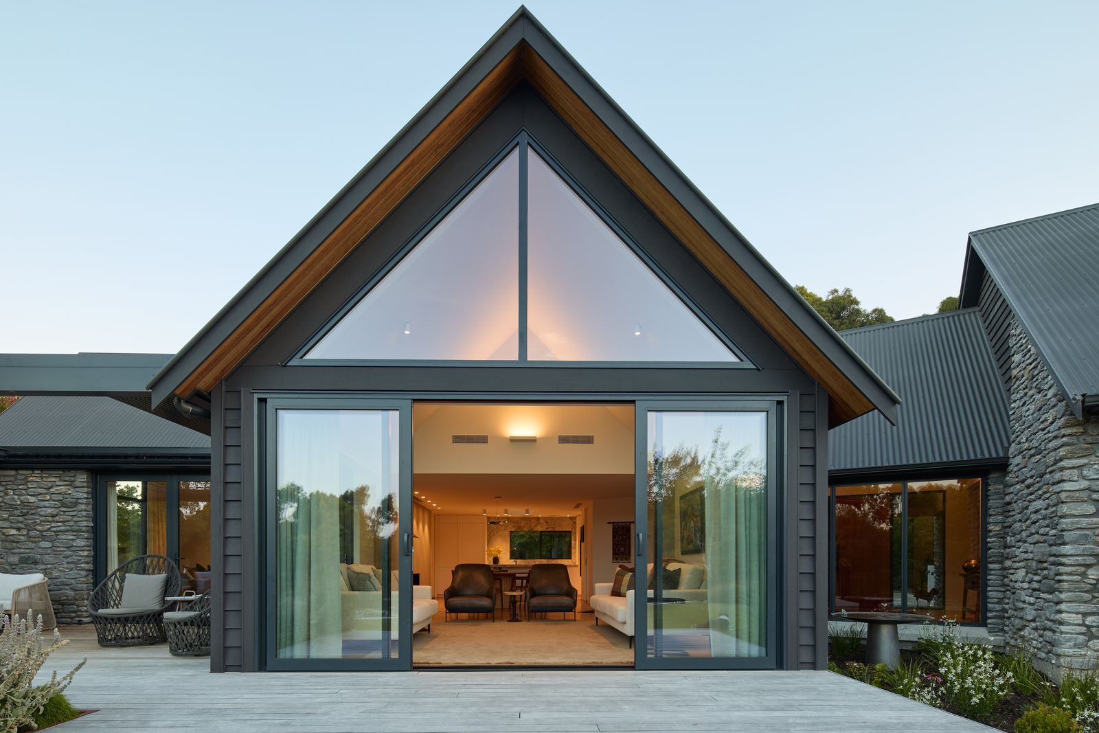 Tai Tapu lakeside home alteration with oak, cedar and clay plaster interiors by AW Architects